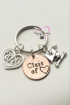 three charms that say class of 2013 and one has a heart shaped keychain