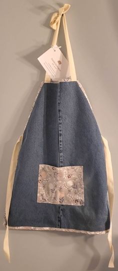 an apron made out of jeans hanging on a wall