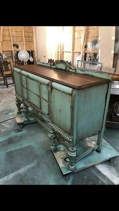 an old dresser is being worked on in a shop