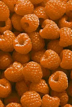 a pile of orange raspberries sitting on top of each other