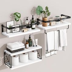 two shelves with towels, toiletries and plants on them