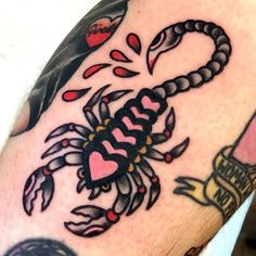 a man's arm with a scorpion tattoo on it, and the words i love you