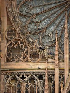 an intricately designed window in the middle of a building with tall spires and large windows