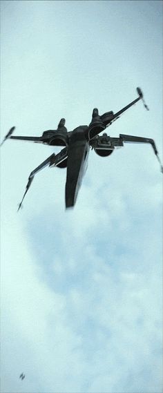 a fighter jet flying through the air with two propellers on it's back end