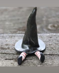 a black witches hat sitting on top of a wooden table next to candy canes