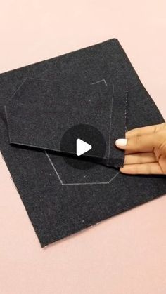 someone is cutting out a piece of fabric with scissors