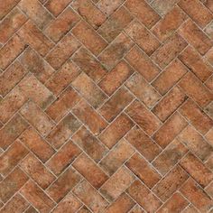 an old brick wall textured with brown and tan tones, as well as the diagonal herringbone pattern