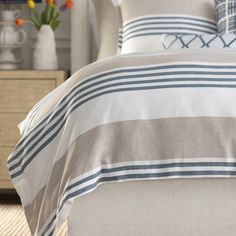 a bed with blue and white striped sheets