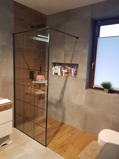 a bathroom with a glass shower door next to a sink