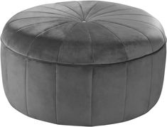 a grey round ottoman that is made out of velvet and has an upholstered design