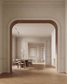 an empty room with wooden floors and white walls is seen from the doorway to the dining area