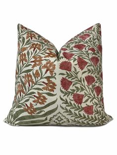 a pillow with red and green flowers on it