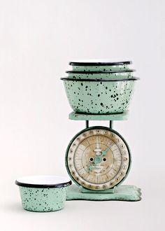 an old fashioned kitchen scale and bowl are on display in front of a white background