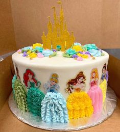 there is a cake decorated with princesses on the top and bottom tiers in different colors