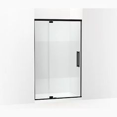 an empty bathroom with a glass door and black trim on the side, against a white wall