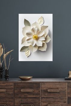 a large white flower is on the wall above a dresser