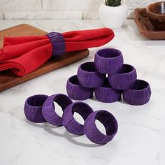 purple napkin rings sitting on top of a white counter