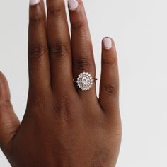 a woman's hand with a diamond ring on it