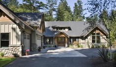 a large house with lots of windows and trees in the background