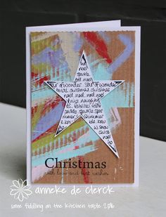 a handmade christmas card with a star on the front and words written in different languages