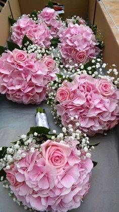 pink flowers in a box with baby's breath