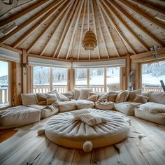 a living room filled with lots of furniture next to a wooden floor covered in snow