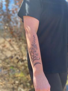 a person with a flower tattoo on their arm