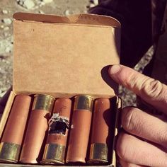 a person holding an open box filled with cigars