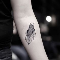 a black and white photo of a corn on the cob tattoo