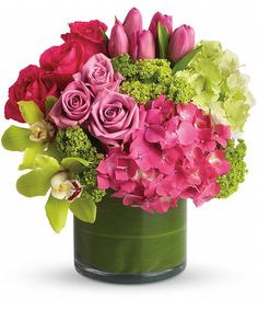 a vase filled with pink and green flowers