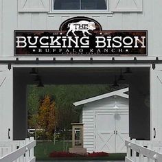 a white building with a sign that says the bucking bison