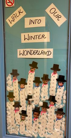 a bulletin board with snowmen and words written on the front door to help students learn how to write