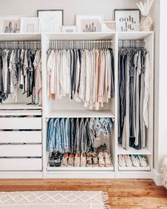 a white closet filled with lots of clothes and other items on top of shelves next to a rug