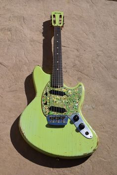 an electric guitar is laying on the ground with its pick up tool attached to it