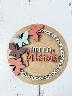 a wooden sign that says hello friends with butterflies on the front and back of it