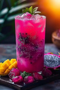 a purple drink with fruit on the side and green leafy garnishes