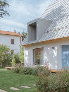 the house is white and has a metal roof