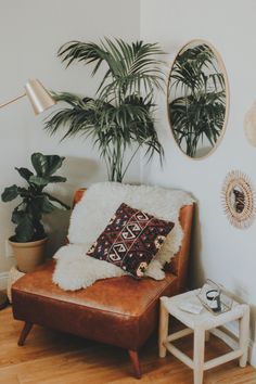 a living room filled with furniture and potted plants