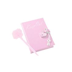 a pink book with two keys and a pom - pom on the cover