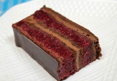 a piece of chocolate cake sitting on top of a white plate