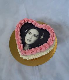 a heart shaped cake with a woman's face on it