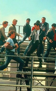 a group of men standing on top of bleachers