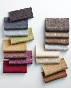 several colors of fabric laid out on top of each other in different sizes and shapes