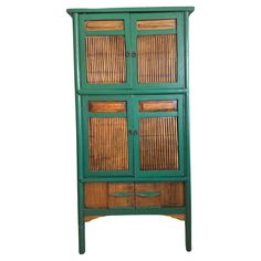 a green cabinet with wicker doors and drawers on the bottom shelf is against a white background