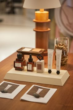 a wooden table topped with three different types of skin care products on top of it