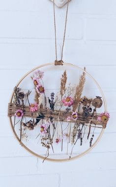 a wooden frame with dried flowers hanging from it