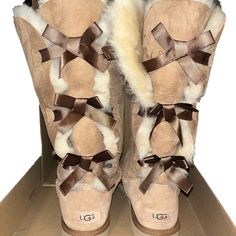 Tall Tan Ugg Boots With Three Bows Down The Back. One Side Of Bow Was Cut But The Boots Are In Great Condition. Uggs With Bows On The Back, Bailey Bow Uggs Ugg, Brown Uggs With Bows, Tall Ugg Boots With Bows, Tan Ugg Boots, Ugg Boots Bailey Bow, Bailey Bow, Bailey Bow Uggs, Ugg Shoes