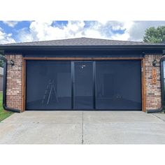 a brick garage with two doors and windows