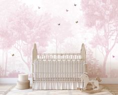 a baby's room with pink wallpaper and white crib in the foreground