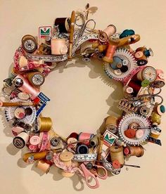 a wreath made out of various sewing items